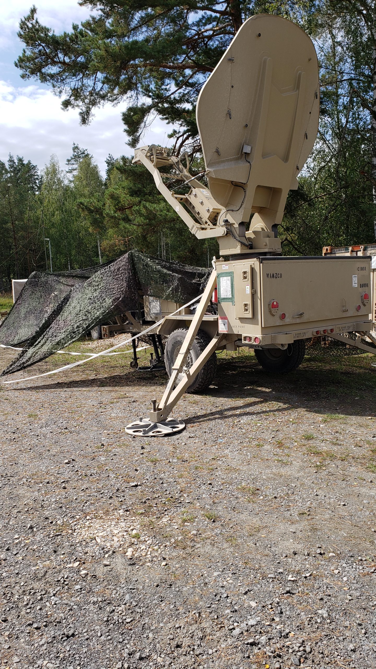 U.S. Army Satellite Transportable Terminal deployed at a field site in Germany.