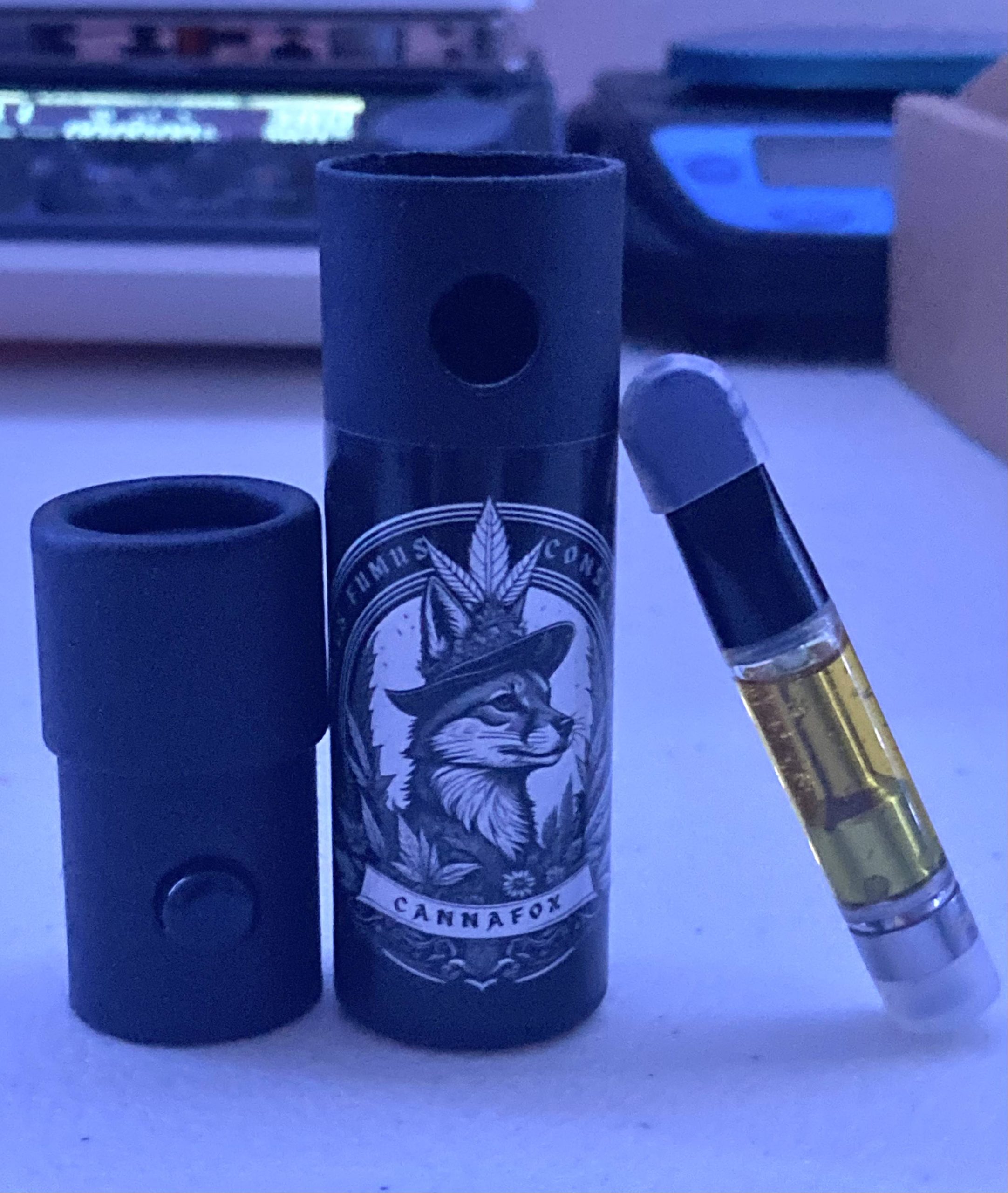 CannaFox cartridge beside its cylindrical child-resistant package